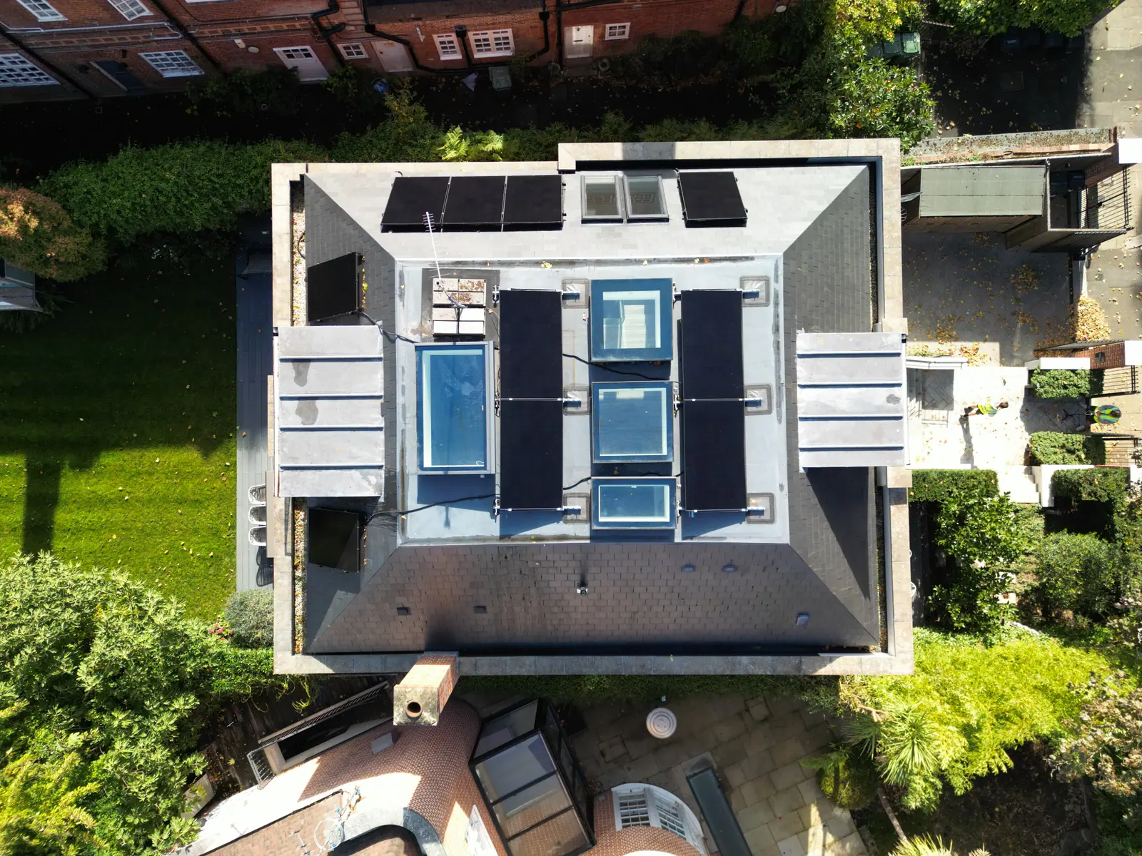 Solar panels we fitted on the flat roof of a London house, between the roof lights