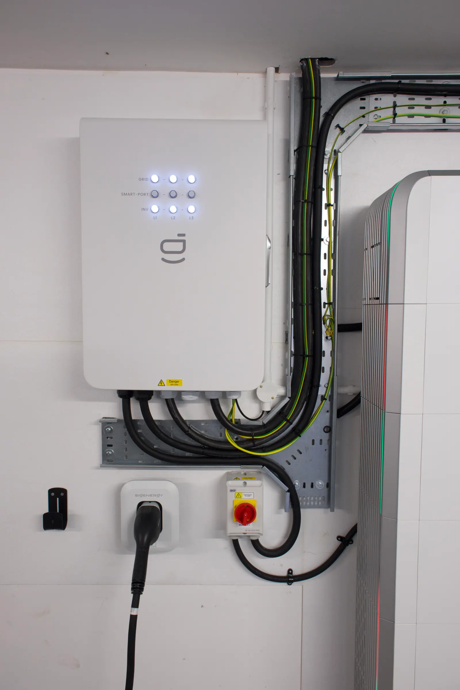 A Sigenergy gateway we installed, with its cables dressed into galvanised tray and an isolator switch below